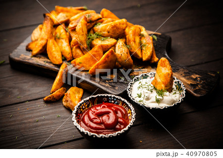 Baked potato fries on wooden table 40970805