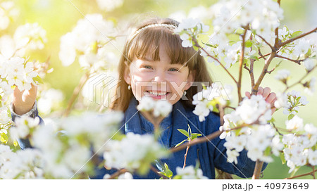 Portrait of a girl in blossoming apple tree. Portrait of a girl in blossoming apple tree. 40973649
