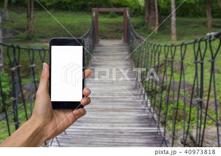 Hand holding black smartphone with white screen. Hand holding black smartphone with white screen. 40973818