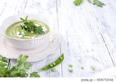 Cream soup of green peas and Parsley. Healthy lunch in a white plate on a white wooden background, 40975048