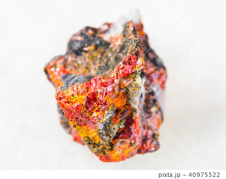 raw Realgar crystals on stone on white 40975522