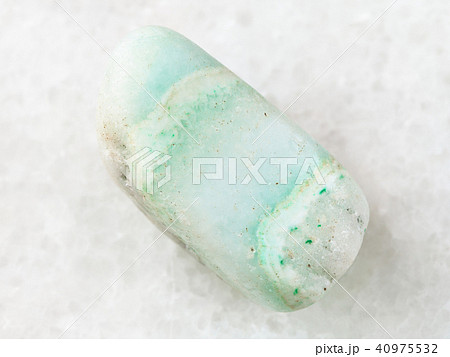 tumbled green Aragonite gemstone on white 40975532