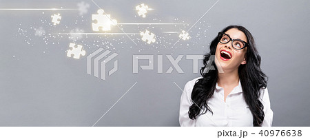 Puzzle Pieces with happy young businesswoman 40976638