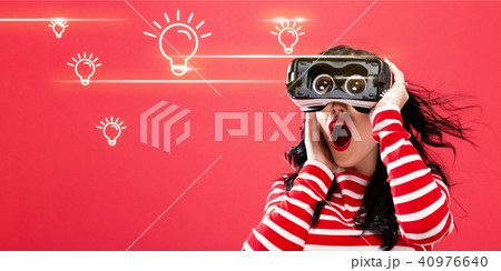 Light Bulbs with woman using a virtual reality headset 40976640