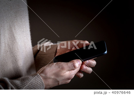 Person's hands using a smartphone Person's hands using a smartphone 40976646