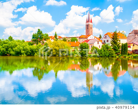 Tower of Church of the Holy Spirit in Telc on sunny summer day reflected in the water, Czech Tower of Church of the Holy Spirit in Telc on sunny summer day reflected in the water, Czech 40979114