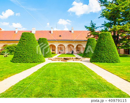 Renaissance internal chateau garden with trim lawn and trees on sunny summer day. Telc, Czech Renaissance internal chateau garden with trim lawn and trees on sunny summer day. Telc, Czech 40979115
