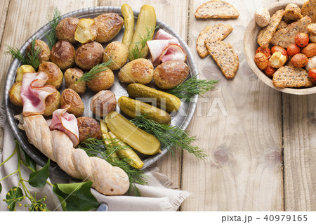Snacks on a plate for a party . Vintage photo. Wooden background. Copy space Snacks on a plate for a party . Vintage photo. Wooden background. Copy space 40979165