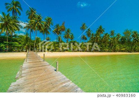 Wooden pier or bridge with tropical beach and sea in paradise island 40983160