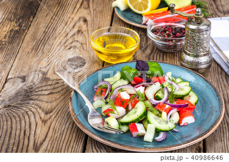 Spicy surimi salad on blue plate Spicy surimi salad on blue plate 40986646