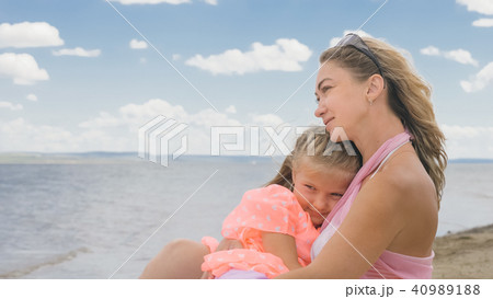 Little cute girl and young mother at beach. 40989188