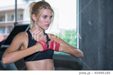 A beautiful woman training with resistance band 40996189