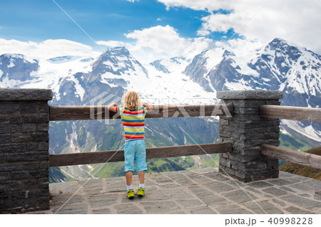 Child hiking in mountains. Kids in snow in spring. Child hiking in mountains. Kids in snow in spring. 40998228