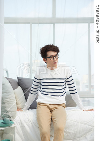 Man resting on bed Man resting on bed 40998921
