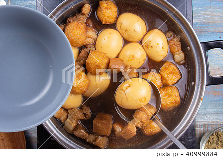 Chef putting streaky pork in pot to bowl Chef putting streaky pork in pot to bowl 40999884
