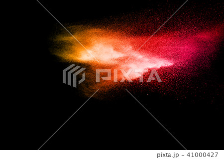 Abstract explosion of red dust on black background Abstract explosion of red dust on black background 41000427