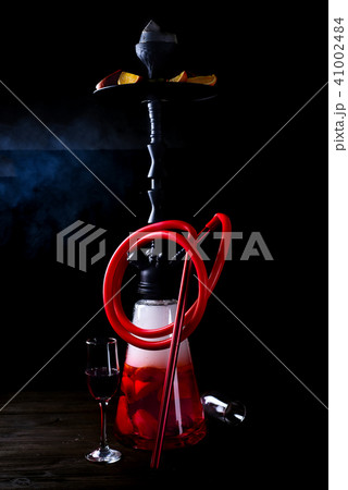 Stylish oriental shisha with fruits on a black background. Shisha Concept Stylish oriental shisha with fruits on a black background. Shisha Concept 41002484