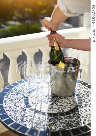 Champagne bottle and four flutes on the table 41002708