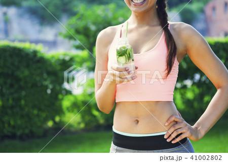 Woman drinking herbal tisane after fitness Woman drinking herbal tisane after fitness 41002802