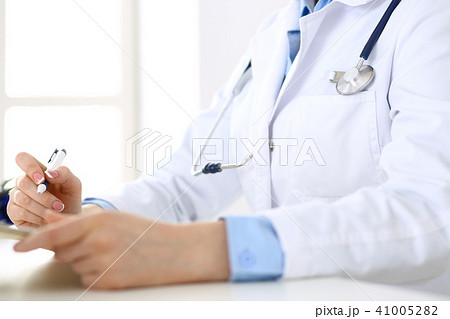 Female doctor filling up medical form on clipboard closeup. Healthcare, insurance and medicine 41005282