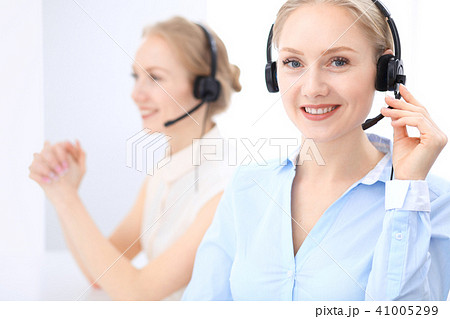 Bright call center office. Two blonde women in a headset Bright call center office. Two blonde women in a headset 41005299