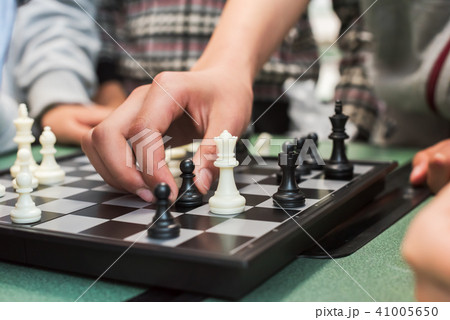 Closeup of children's hand playing chess Closeup of children's hand playing chess 41005650
