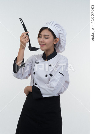 portrait of asia clef woman with ladle on white 41007035