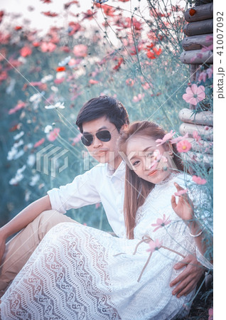 Asia loving couple in blossom spring garden 41007092