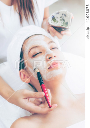 Beautiful woman having a facial treatment at spa. Beautiful woman having a facial treatment at spa. 41008078