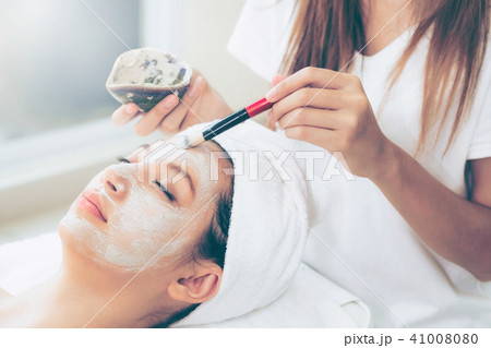 Beautiful woman having a facial treatment at spa. Beautiful woman having a facial treatment at spa. 41008080
