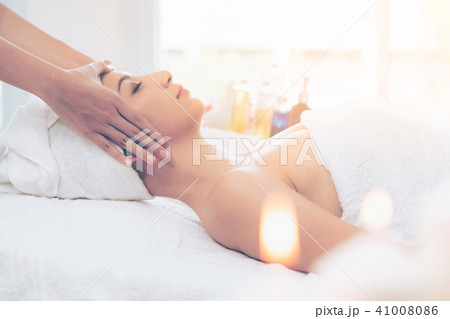 Relaxed woman gets facial and head massage in spa. Relaxed woman gets facial and head massage in spa. 41008086