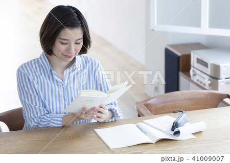 女性 カフェ 読書 おしゃれの写真素材