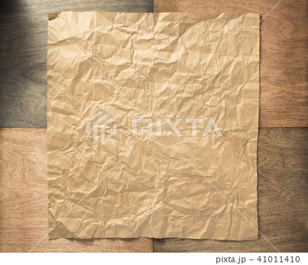wrinkled paper at wooden background 41011410