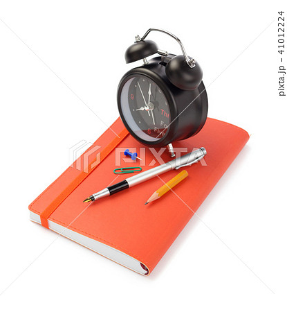 notebooks and alarm clock at white background 41012224
