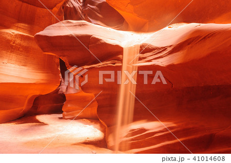 Sand Flowing off the Red Rocks of Antelope Canyon 41014608