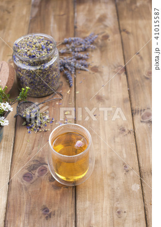 A mix of herbal tea with lavender, on a wooden background. Vintage photo. Free space for the text. 41015587