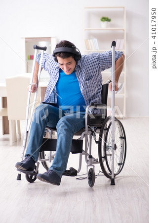 Disabled man listening to music in wheelchair Disabled man listening to music in wheelchair 41017950
