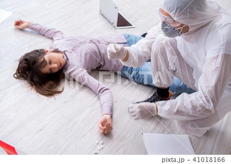 Forensic investigator at the crime scene investigating woman mur 41018166