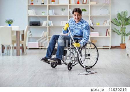 Disabled man on wheelchair cleaning home Disabled man on wheelchair cleaning home 41020216