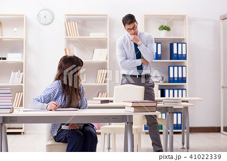 Male lecturer giving lecture to female student Male lecturer giving lecture to female student 41022339
