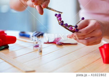 Woman making jewelry at home Woman making jewelry at home 41022802