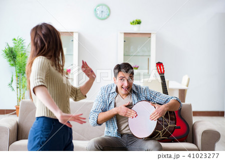 Young family singing and playing music at home Young family singing and playing music at home 41023277