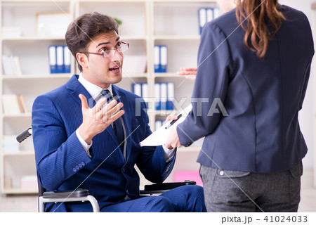 Disabled businessman having discussion with female colleague 41024033