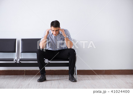 Man nervously impatiently waiting in the lobby 41024400