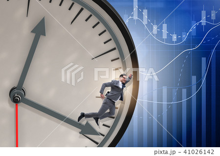 Businessman in time management concept Businessman in time management concept 41026142