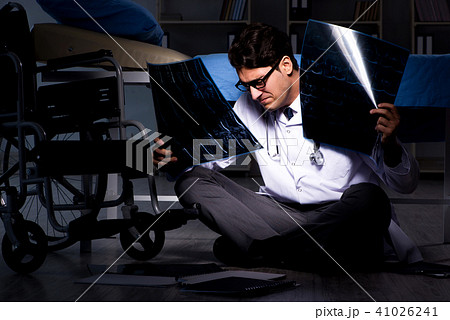Doctor working night shift in hospital after long hours Doctor working night shift in hospital after long hours 41026241