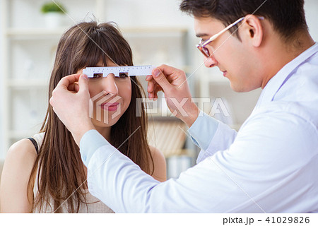 Ophthalmologist is checking up patient in eye doctor hospital Ophthalmologist is checking up patient in eye doctor hospital 41029826