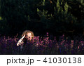 Young woman in a field with wild flowers. 41030138