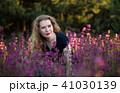 Young woman in a field with wild flowers. 41030139