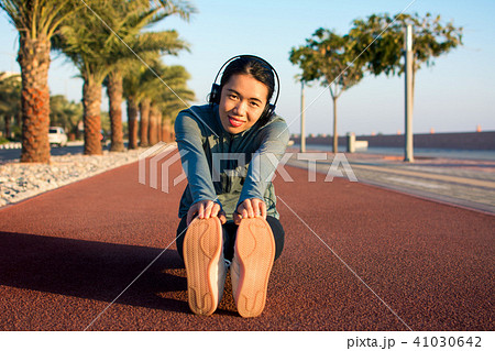 Girl warming up on a running track before workout 41030642